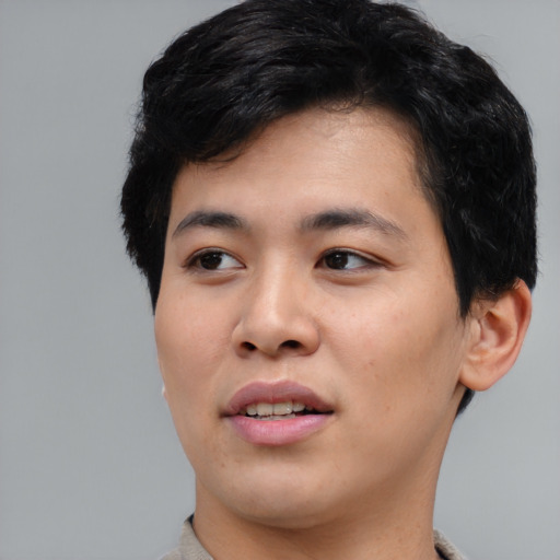 Joyful asian young-adult male with short  black hair and brown eyes