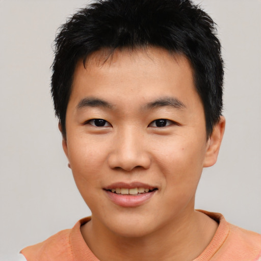 Joyful asian young-adult male with short  black hair and brown eyes