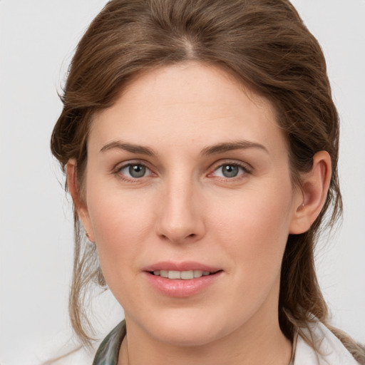 Joyful white young-adult female with medium  brown hair and grey eyes