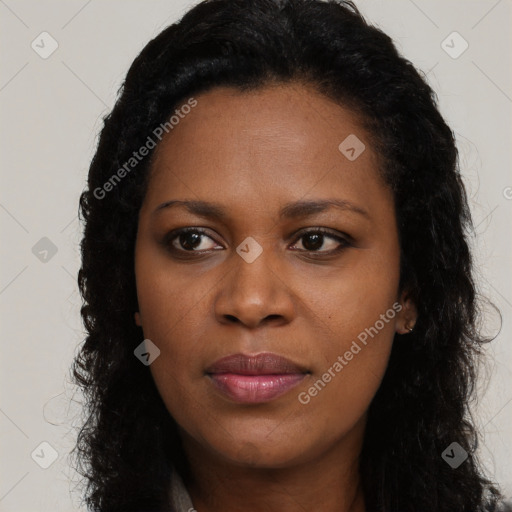 Joyful black young-adult female with long  brown hair and brown eyes