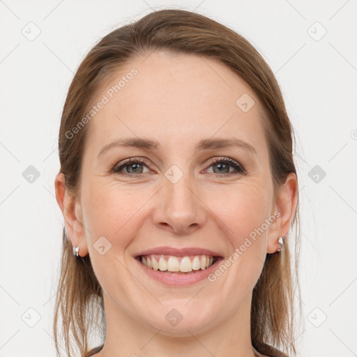 Joyful white young-adult female with long  brown hair and grey eyes