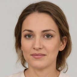 Joyful white young-adult female with medium  brown hair and green eyes