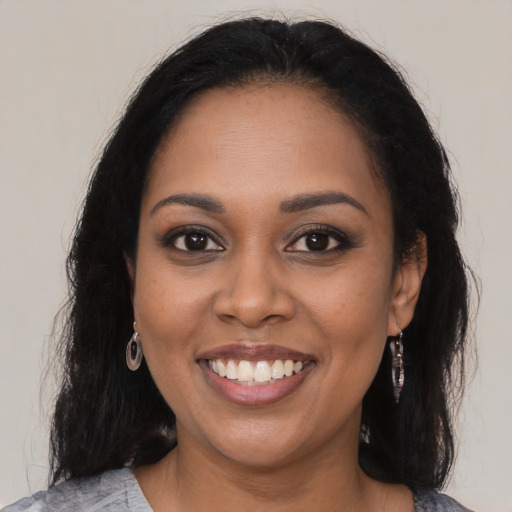 Joyful black young-adult female with medium  brown hair and brown eyes