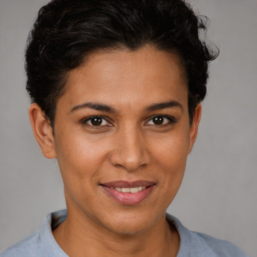 Joyful latino young-adult female with short  brown hair and brown eyes