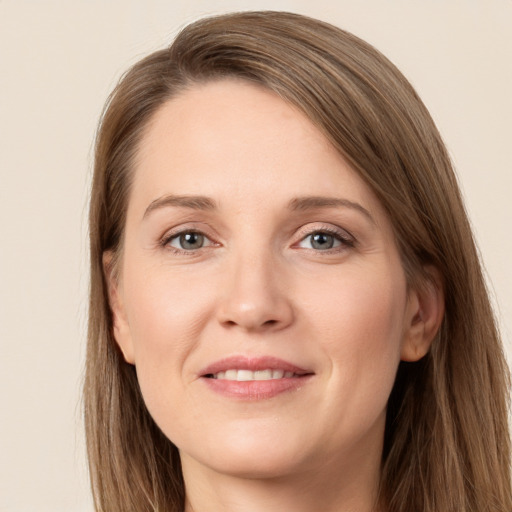 Joyful white young-adult female with long  brown hair and grey eyes