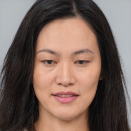 Joyful asian young-adult female with long  brown hair and brown eyes