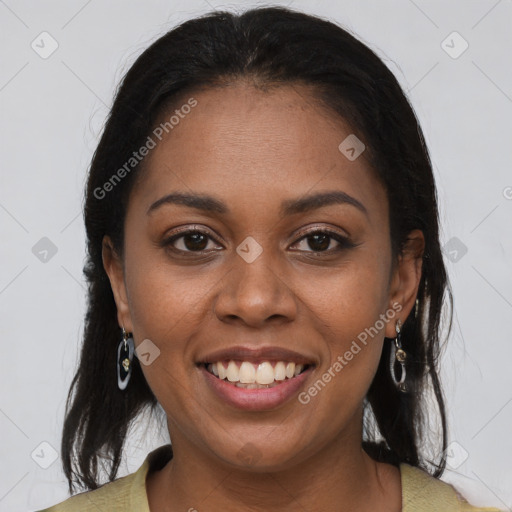 Joyful black young-adult female with long  brown hair and brown eyes