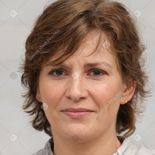 Joyful white adult female with medium  brown hair and blue eyes