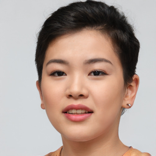 Joyful asian young-adult female with short  brown hair and brown eyes