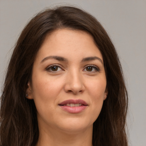 Joyful white young-adult female with long  brown hair and brown eyes