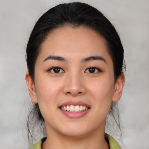 Joyful white young-adult female with medium  black hair and brown eyes