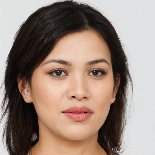 Joyful asian young-adult female with long  brown hair and brown eyes