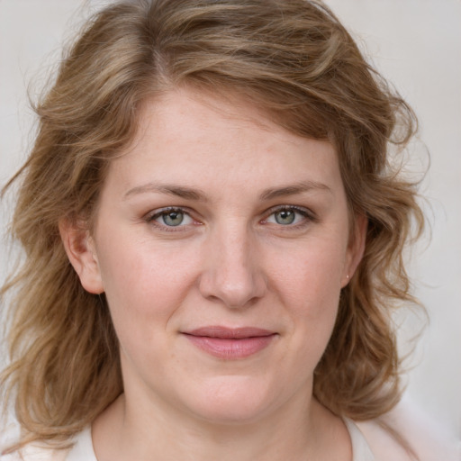 Joyful white young-adult female with medium  brown hair and blue eyes