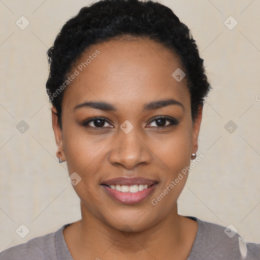 Joyful black young-adult female with short  black hair and brown eyes