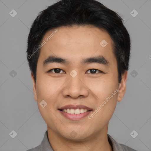 Joyful asian young-adult male with short  black hair and brown eyes