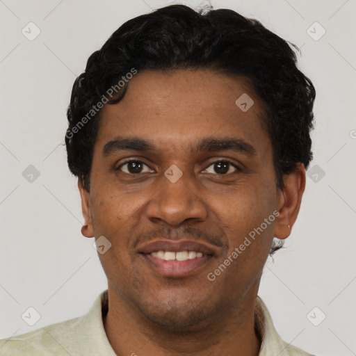 Joyful black young-adult male with short  black hair and brown eyes