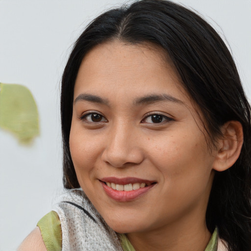Joyful asian young-adult female with medium  brown hair and brown eyes