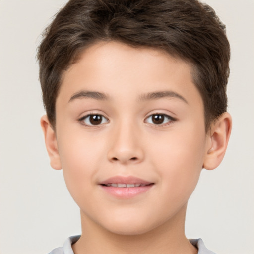 Joyful white child male with short  brown hair and brown eyes