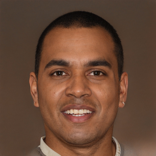 Joyful black young-adult male with short  brown hair and brown eyes
