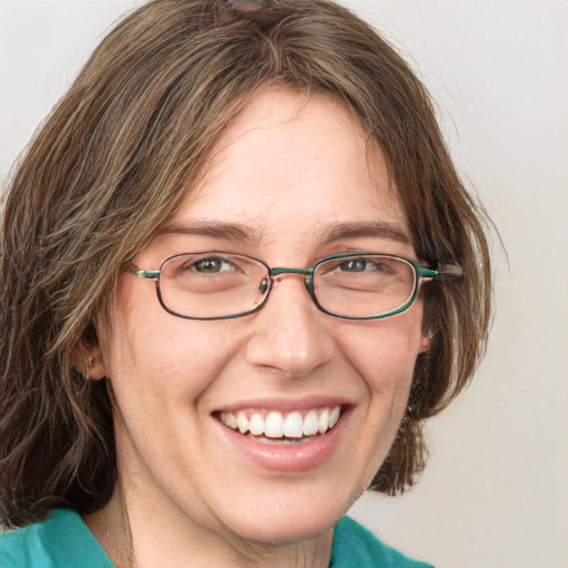 Joyful white adult female with medium  brown hair and blue eyes