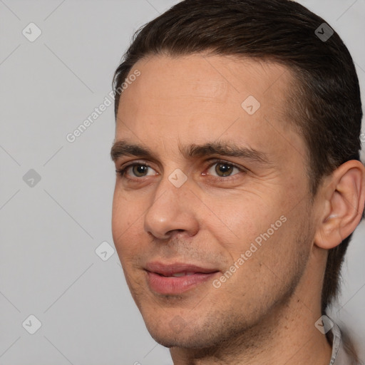 Joyful white adult male with short  brown hair and brown eyes