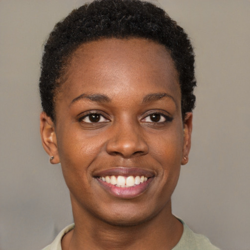 Joyful black young-adult female with short  brown hair and brown eyes