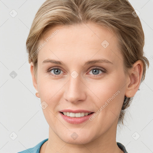 Joyful white young-adult female with medium  brown hair and blue eyes