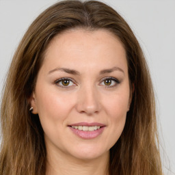 Joyful white young-adult female with long  brown hair and green eyes