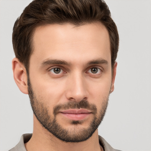 Joyful white young-adult male with short  brown hair and brown eyes