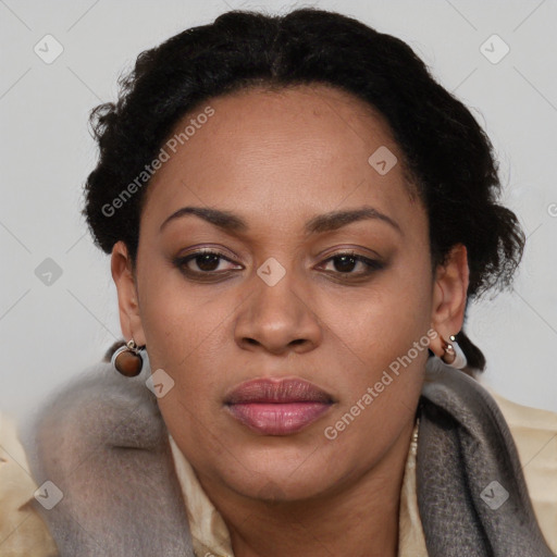 Joyful black adult female with long  black hair and brown eyes