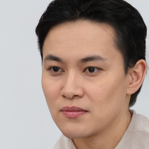 Joyful asian young-adult female with short  black hair and brown eyes