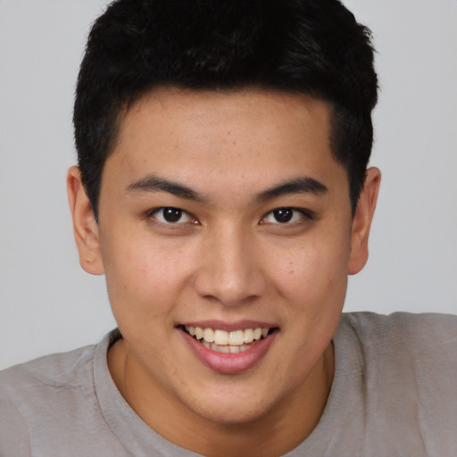 Joyful asian young-adult male with short  brown hair and brown eyes