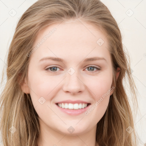 Joyful white young-adult female with long  brown hair and blue eyes