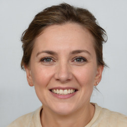 Joyful white adult female with medium  brown hair and brown eyes