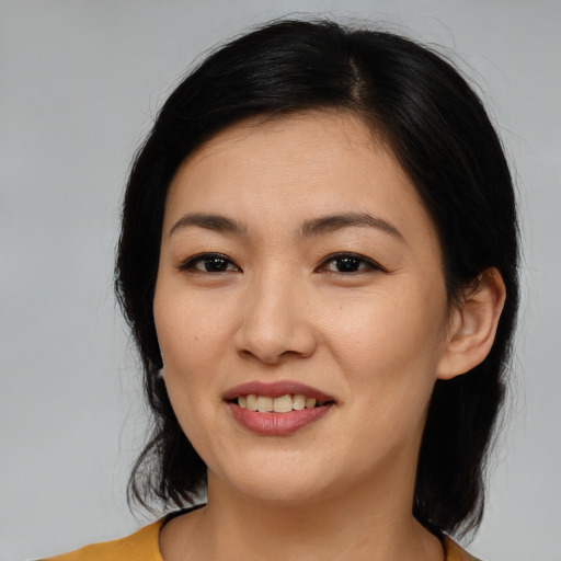 Joyful white young-adult female with medium  black hair and brown eyes