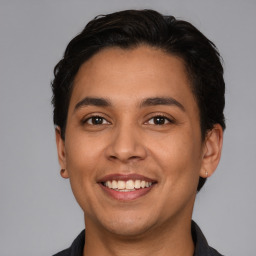 Joyful latino young-adult male with short  brown hair and brown eyes