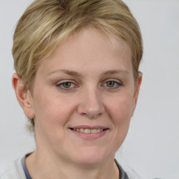 Joyful white young-adult female with medium  brown hair and blue eyes