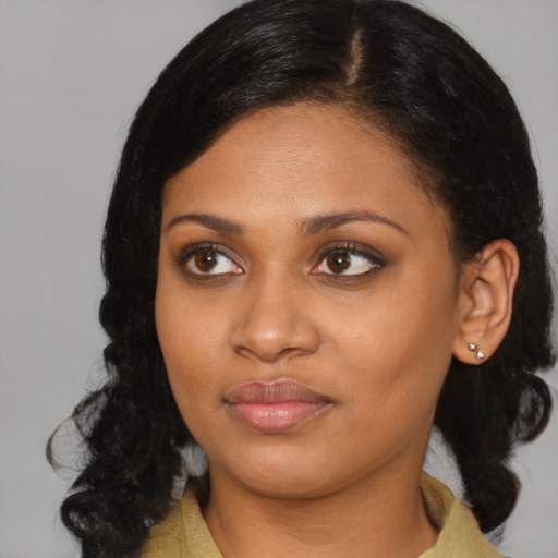 Joyful black young-adult female with medium  black hair and brown eyes