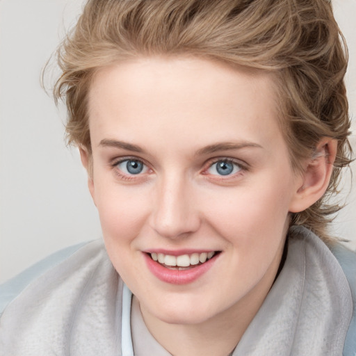 Joyful white child female with medium  brown hair and blue eyes