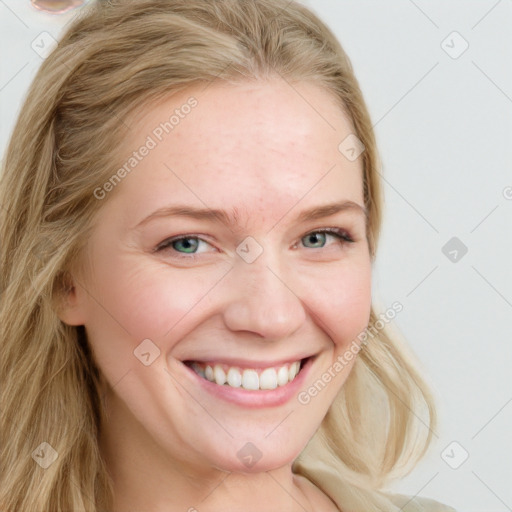 Joyful white young-adult female with long  brown hair and blue eyes