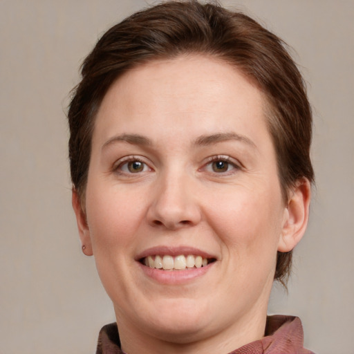 Joyful white adult female with medium  brown hair and grey eyes