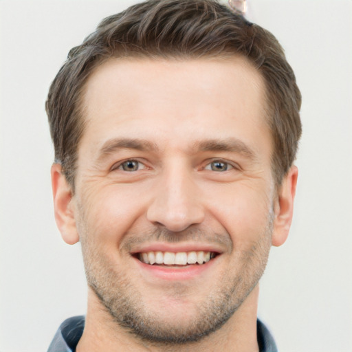 Joyful white adult male with short  brown hair and brown eyes