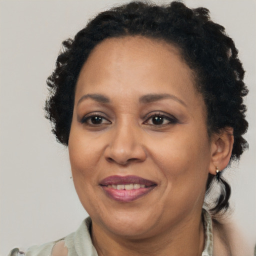 Joyful latino adult female with short  brown hair and brown eyes