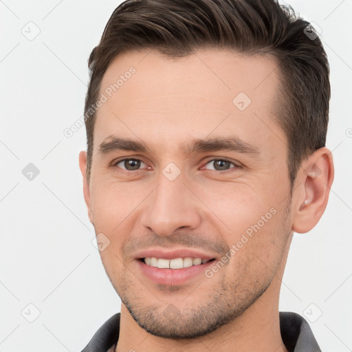 Joyful white young-adult male with short  brown hair and brown eyes