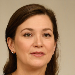 Joyful white adult female with long  brown hair and brown eyes