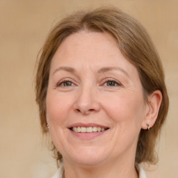 Joyful white adult female with medium  brown hair and grey eyes