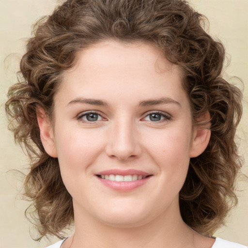 Joyful white young-adult female with medium  brown hair and green eyes