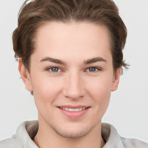 Joyful white young-adult female with short  brown hair and grey eyes