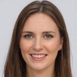 Joyful white young-adult female with long  brown hair and grey eyes