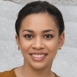 Joyful latino young-adult female with short  brown hair and brown eyes